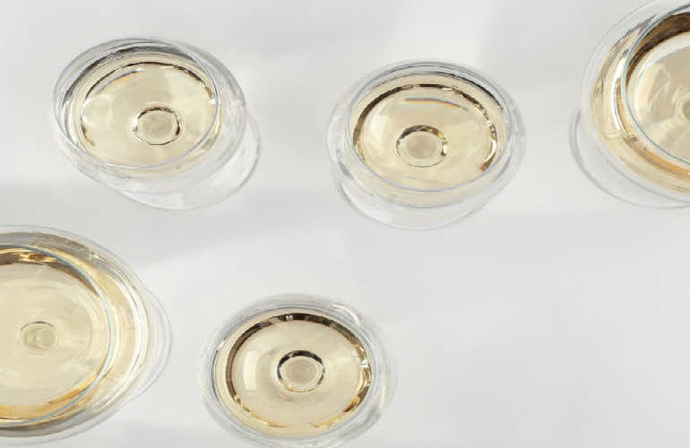 different wine glasses filled with white wine