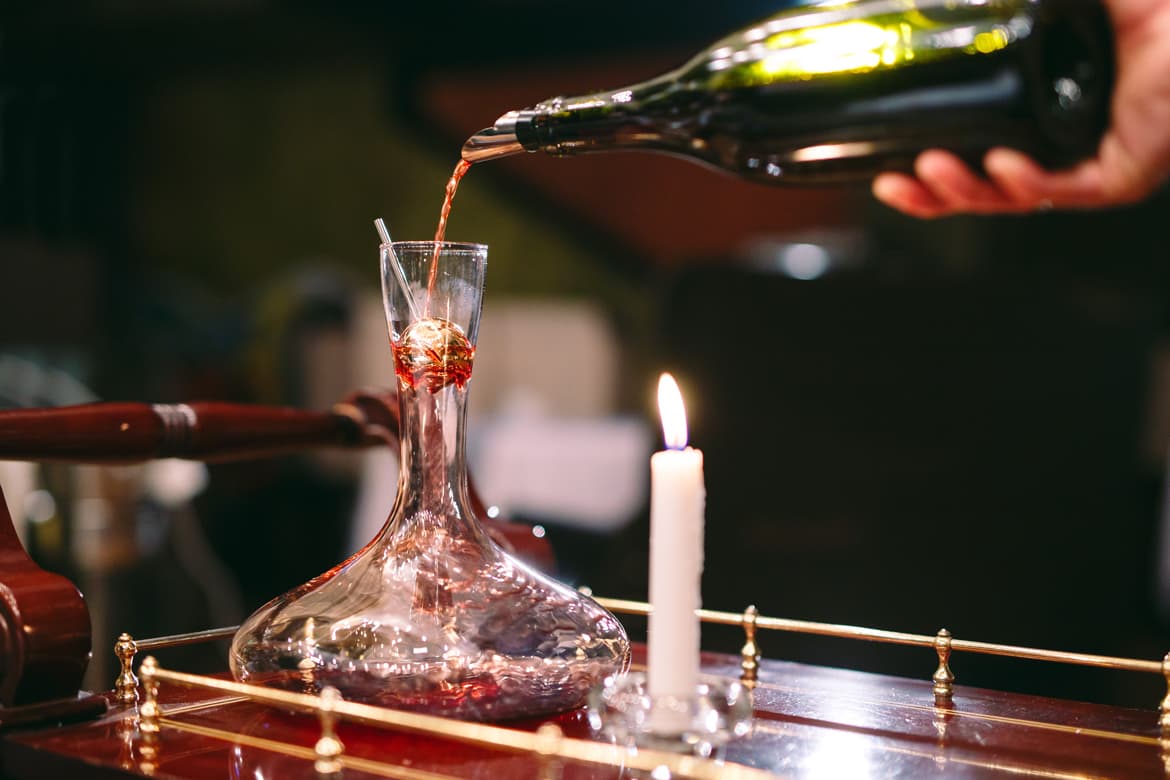 Pouring red wine into decanter